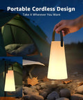 Hand holding Rechargeable Cordless Outdoor Lanterns With Dope RGB Colors at night by a camping tent