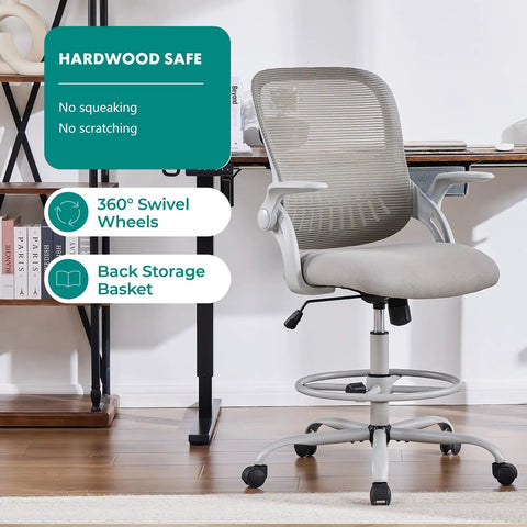 Grey ergonomic mid back mesh chair on wheels, drafting chair for standing desks with flip up arms in home office.