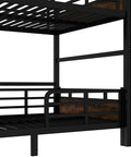 Close-up of black metal full-over-full bunk bed frame with guardrails and slatted bunks