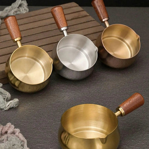 Gold and silver stainless steel espresso measuring cups with wooden handles and V spouts for brewing, 6 oz, 180 ml.