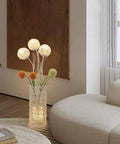 Pastoral LED Floor Lamp With Handwoven Rattan Flower Shade, modern cozy vibe lamp in living room with beige sofa.