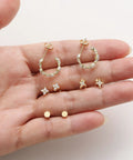 Gold Plated Earring Set For Women 9 Pairs Including Huggie Hoops Planet Ball Flower Dangle Studs Flat Back Cartilage Tragus Earrings For Multiple Piercings Stackable Jewelry Perfect For Everyday Vibe. Gold plated 9-pair earring set on hand.