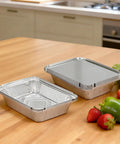 60 Pack Aluminum Foil Pans With Lids, 8.5 By 6 Inch, 2.25 Lb Capacity, placed on kitchen counter with fresh vegetables