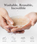 Person holding silicone nipple covers under water stream, showcasing "Washable, Reusable, Incredible." Silicone Nipple Covers With Travel Case Reusable Nipple Pasties With Skin Safe Adhesive No Bra Needed Under Clothing For Backless Dresses Bridesmaid Gowns Camisoles And Swimwear Creme Size 1 Fits A Cups.