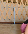 Wood Expansion Pet Gate For Stairs And Open Layout Homes, 108-Inch Reach, adjustable, close-up of latch and wood design, floor view.
