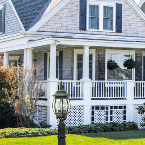 Traditional Style Outdoor Post Light With Clear Beveled Glass Panels In Black Finish in front of a classic home exterior