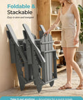 Easy Fold Adirondack Chair Built For Chill Outdoor Vibes with wood texture finish, folded against wall, plastic HDPE, grey, indoor setting