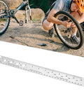 Top Shelf Stainless Steel Bike Spoke Length Gauge And Nipple Size Ruler For Cotter Pins And Bearings Dead On 360Mm Double Sided Workshop Measuring Tool beside cyclist repairing a bike tire.