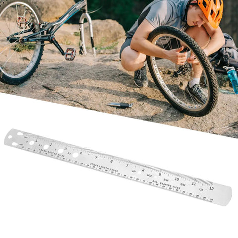 Top Shelf Stainless Steel Bike Spoke Length Gauge And Nipple Size Ruler For Cotter Pins And Bearings Dead On 360Mm Double Sided Workshop Measuring Tool beside cyclist repairing a bike tire.
