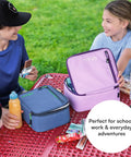 Keep Your Grub Fridge Cold All Day With This Straight Up Sweet Soft Sided Lunch Bag Featuring Double Ice Packs For Office Grind School Runs And Weekend Adventures In Smooth Lavender, shown in a park with a boy and girl enjoying snacks.
