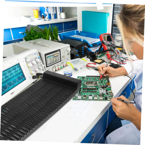 Anti Static PCB Tray Storage Rack For Circuit Boards on a workbench with electronics equipment and technician soldering