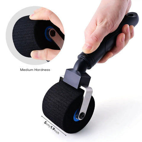 Hand holding Two Inch Foam Seam Roller For Vinyl Wrap On Uneven Textured Surfaces And Car Wrapping Rivet Roller Tool