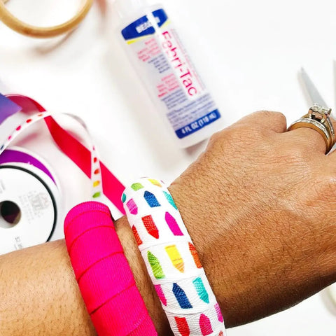 Close-up of hand showing Fast Drying Fabric Glue For Fabrics Canvas Lace Wood And More That Dries Crystal Clear In Minutes 8oz bottle