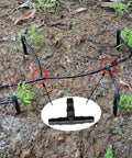 Irrigation barbed fittings kit for 1/4in tubing; black plastic tubing laid in garden; inset shows T-fitting.