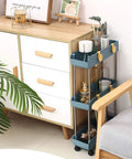 Three Tier Slim Mobile Shelving Unit On Wheels With Slide Out Storage Cart For Kitchen Bathroom Laundry Room And Small Nooks In Narrow Spaces Navy Blue Ultimate Utility Cart Organizer next to a white dresser and chair, holding cups and miniature potted plants.