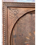 Close-up of hand-carved design on custom solid wood barn door, rustic Moroccan inspired, 71x34 inches, no glass or hardware included.