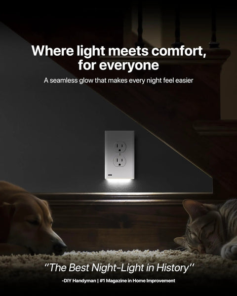 GuideLight Duplex Outlet Night Light With LED Sensor glowing on wall under stairs, two dogs sleeping nearby, grey wall background