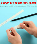 Hands tearing masking tape from Easy DIY Curb Address Stencil Kit With 0-9 Reusable Plastic Number Stencils, Includes 2 Rolls Masking Tape For Fast, Clean Painting Of Addresses On Walls, Wood, Mailboxes, Curb Or Road, 4 Inch High.