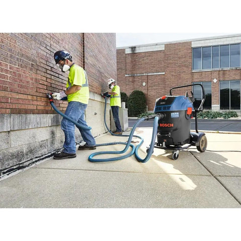 Two Hose Vacuum Y Connector For Dust Extractor System With Secure Fit Port and Tethered Cap in use on construction site