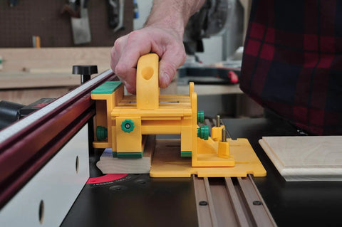 Killer Table Saw 3D Grip Pushblock With Dead Solid Kickback Stopping Guard and Sliding Blade Shield in use on wood.