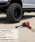 Heavy Half Inch Air Impact Wrench Pumping Out One Six Zero Zero Foot Pounds Of Torque Inside A Featherlight Four Point Four Pound Body With An Eight Piece Socket Set For Zero Fatigue Work And Quick Fixes Utilizing Its Soft Rubber Grip To Slash Shake And next to a large off-road tire.
