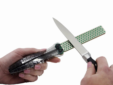 Hands using Dia Fold Handy Portable Pocket Diamond Sharpener Double Sided With Extra Fine And Fine Grits Coarse And Extra Coarse Options
