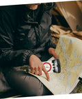 Person using Multifunctional Orienteering Compass With Luminous Pointer Scale Ruler And Mirror For Hiking Camping And Outdoor Survival Navigation