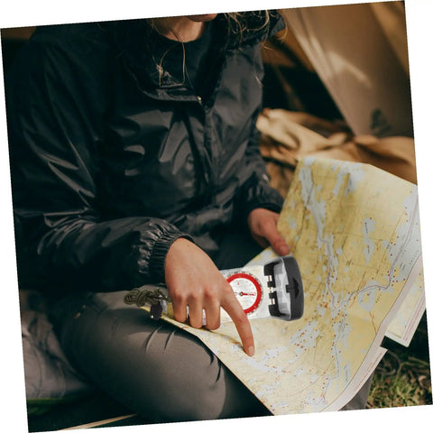 Person using Multifunctional Orienteering Compass With Luminous Pointer Scale Ruler And Mirror For Hiking Camping And Outdoor Survival Navigation
