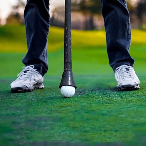 Golf Ball Retriever Suction Cup Putter Grip Tool held by golfer picking up ball on green