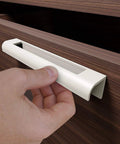 Installing self adhesive edge fingerpull door handle on wooden drawer front for quick transform of kitchen fronts and furniture.