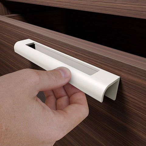 Installing self adhesive edge fingerpull door handle on wooden drawer front for quick transform of kitchen fronts and furniture.