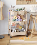 Beige 3 Tier Rolling Cart With Metal On Wheels A Spacious Multi Purpose Storage Organizer Trolley in a craft room setting