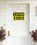 Funny Dope Caution Overhead Equipment Metal Sign 8x12 Inch Aluminum Wall Decor hanging on white door with plants