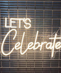 "LET'S Celebrate" LED neon sign on metal grid, 23.6 inch warm white glow, for wall decor, indoor bedroom, home, weddings, Christmas.
