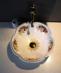 Floral-patterned ceramic vessel sink on countertop with dark faucet