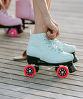 Red 92A Quad Roller Skate Wheels Replacement For Speed Skates Indoor Outdoor Use on a light blue skate on wood deck