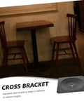 Heavy Duty Cast Iron Table Leg Connectors Lock Down Wobbly Furniture Fast No Sweat Rock Solid Stability For Your Favorite Tables And Chairs DIY Friendly Furniture Hardware seen on a black table with wooden chairs in a cafe.