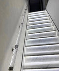 Built Like A Tank Clear Acrylic Stair Railing Kit With Heavy Duty Silver Brackets installed along illuminated staircase for safety.