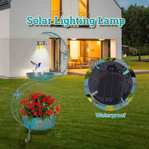 Bird Bath With Flower Planter Base And Solar Lighting Pedestal For Outdoors next to a modern house, lit at dusk.