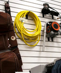 Rugged Outdoor Extension Cord With Lighted Ends For Easy Power Check 15 Amp 1875 Watts Bright High Visibility Yellow Jacket For Jobsites And Yard Work Weather Resistant coiled on wall