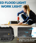 Woman using drill indoors with enlarged view of 2 Pack 100W LED Flood Lights Outdoor With 10000LM Each, IP65 Waterproof 6000K Exterior Floodlight's heat sink.