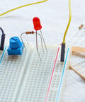 Trim Potentiometer Kit With Blue Knobs 20 Pieces 1K 10K 50K 100K Ohm Breadboard Friendly Rotary Potentiometers For Electronics Projects DIY Prototyping Fine Tuning And Repairs on a breadboard with red LED and resistors.