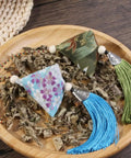 10 Pack Mugwort Triangle Sachets With Tassels Dragon Boat Festival Zongzi Shape Home Decor Bags Premium Cotton Fabric on a plate