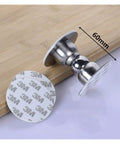 Heavy Duty Stainless Steel Door Stops For Home With Magnetic Noiseless Catch To Hold Doors Open Securely On Walls And Skirting Boards In Bedrooms Bathrooms And Offices. Close-up of door stop and adhesive base on wooden surface.