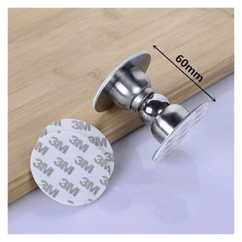 Heavy Duty Stainless Steel Door Stops For Home With Magnetic Noiseless Catch To Hold Doors Open Securely On Walls And Skirting Boards In Bedrooms Bathrooms And Offices. Close-up of door stop and adhesive base on wooden surface.
