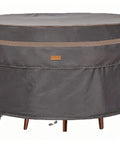Heavy Duty Round Patio Table And Chair Cover 84 Inch Diameter 28 Inch High Waterproof UV Resistant Dark Grey Fits 84 Inch Tables Or 47 Inch Tables With Chairs Outdoor Weatherproof Protection shown covering furniture on patio.