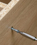 Close-up of M6.3 X 50mm hex socket countersunk self tapping furniture screw being installed into wood panel, carbon steel zinc plated.