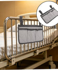 Bed Rail Organizer With 4 Pockets And Cup Holder, Universal Bedside Caddy in gray on a hospital bed with dark trim detail