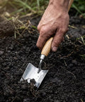Using long handle garden shovel with stainless steel blade and wooden handle for digging soil, ergonomic design on display.