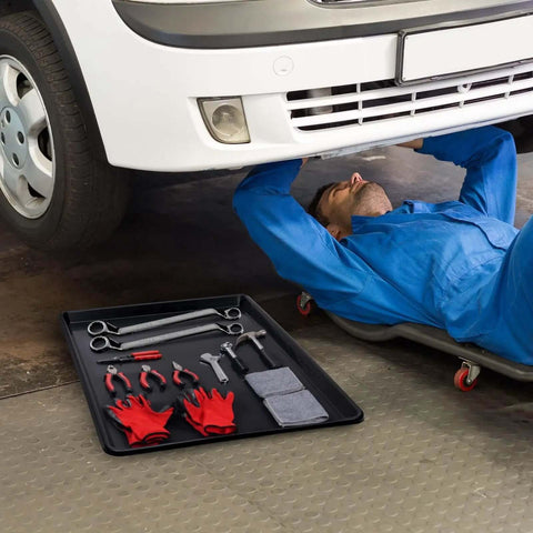 Mechanic under car with Triple Pack Extra Large Oil Drip Pan 35.4 X 24 Inch Heavy Duty Plastic Drain Tray for Car Maintenance